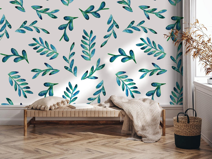 a room with a bed and a wall with a painting of leaves on it