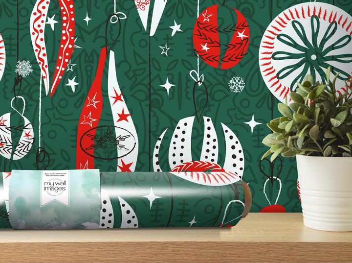 a green christmas wrapping with red and white ornaments