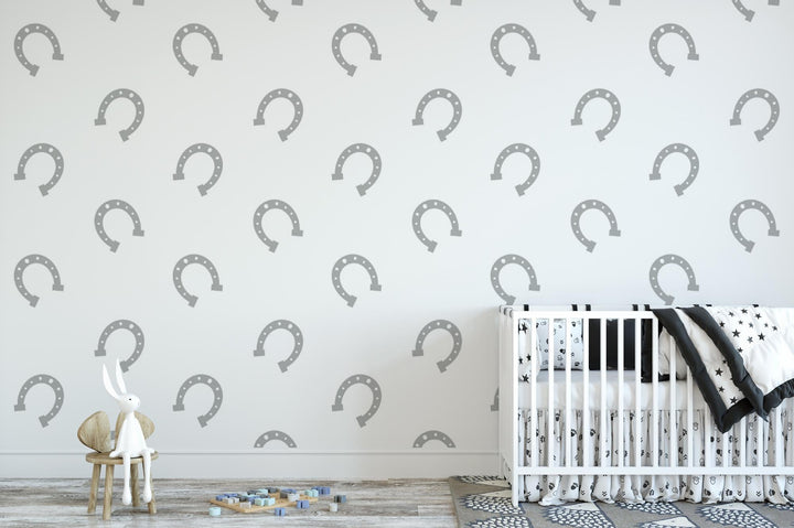 a baby&#39;s room with a crib and wallpaper