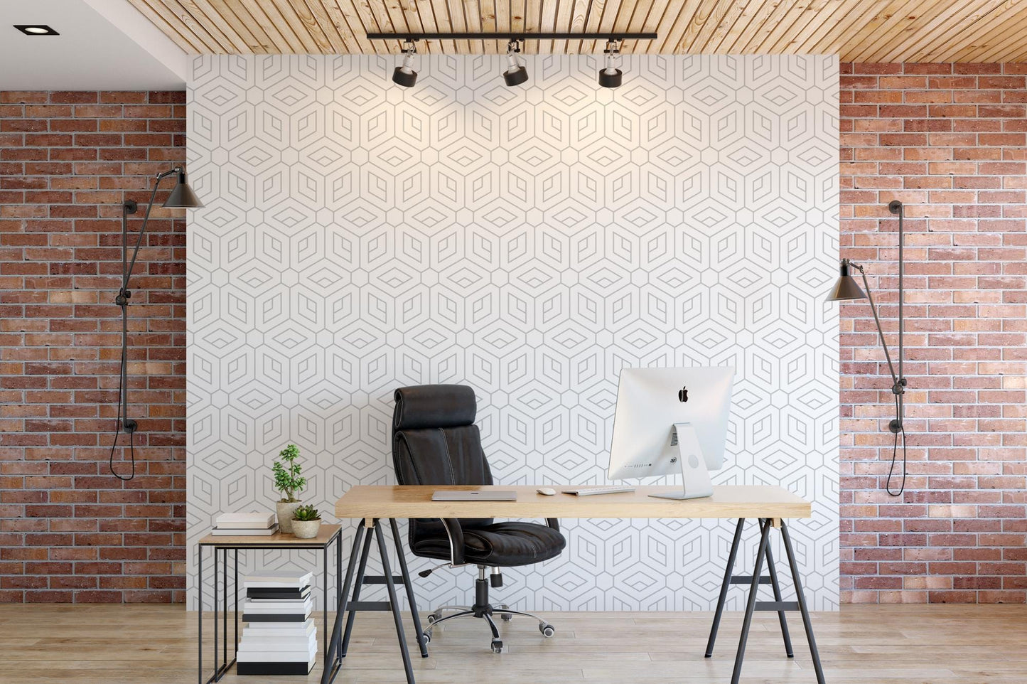 a desk with a computer on it in front of a brick wall