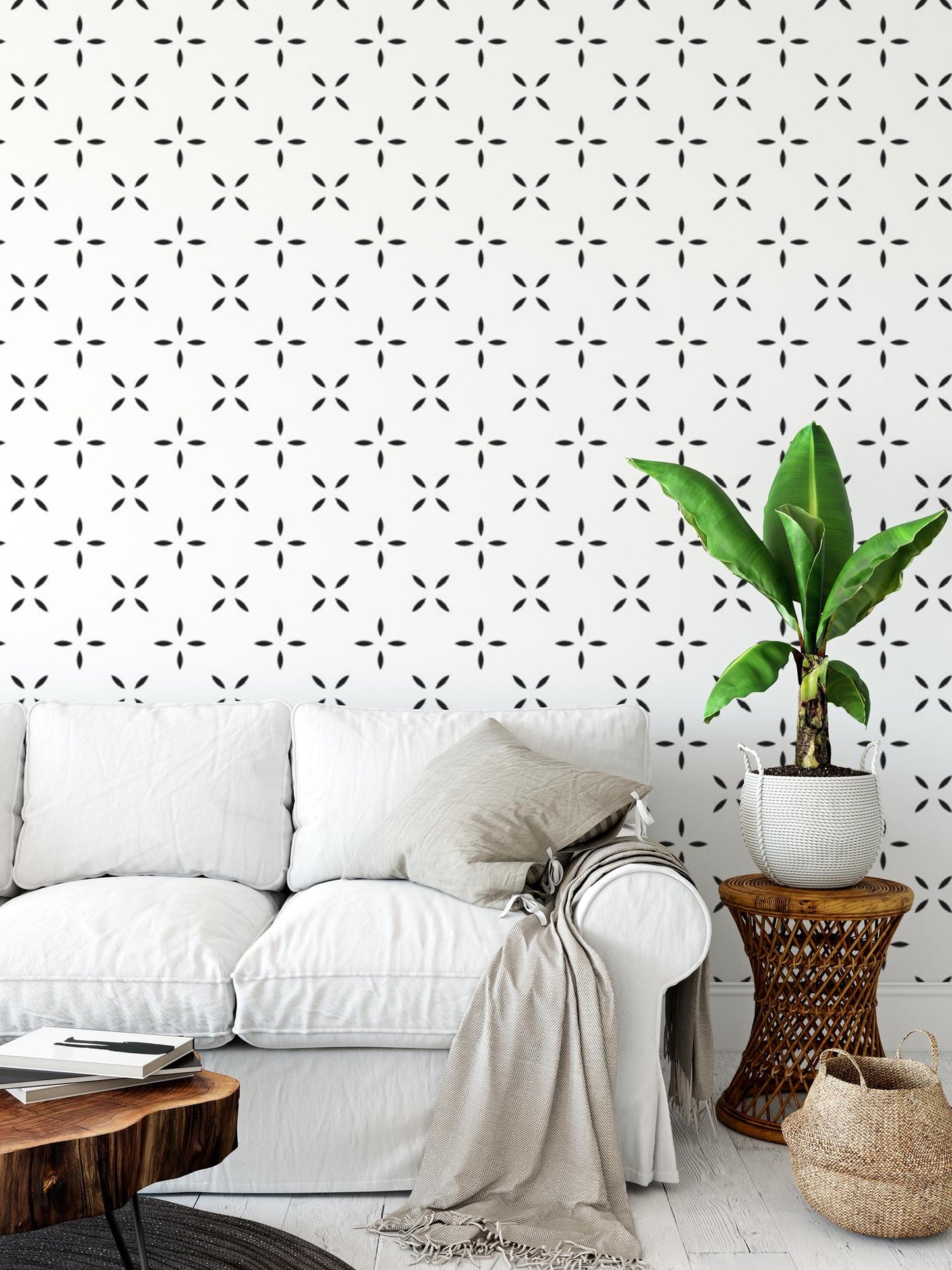 a living room with a white couch and a potted plant