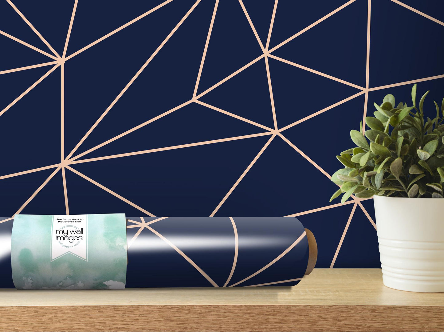a plant in a white vase next to a blue wall