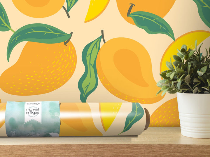 a vase with a plant next to a wallpaper with oranges on it