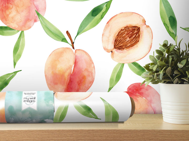 a painting of peaches on a wall next to a potted plant