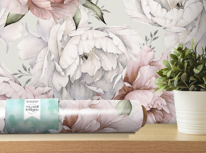 a vase of flowers and a roll of wrapping paper on a table