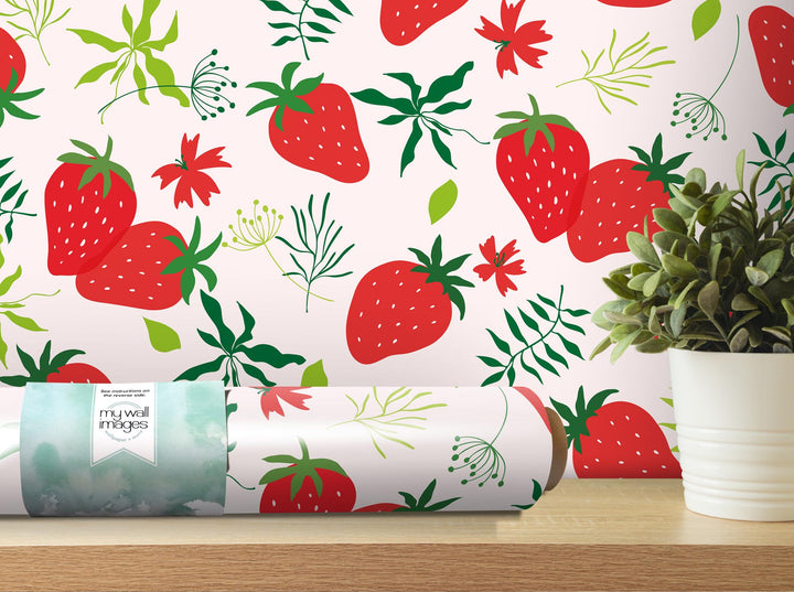 a wallpaper with strawberries on it next to a potted plant