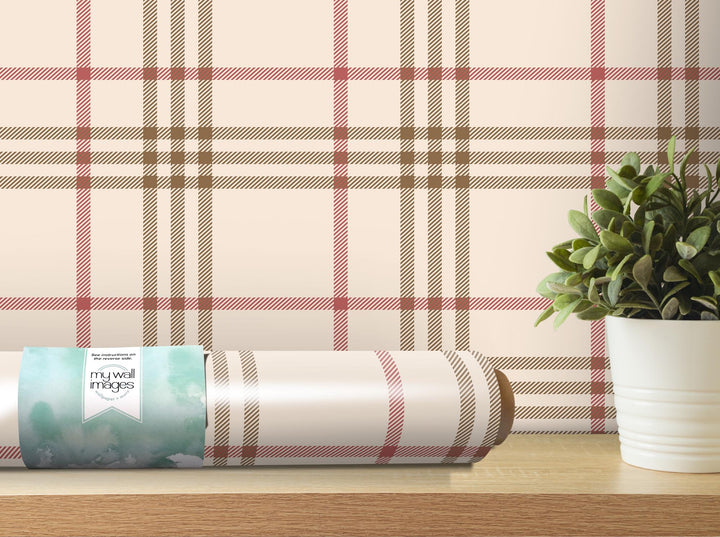 a potted plant sitting on a table next to a roll of toilet paper