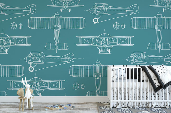 a baby&#39;s room with a crib and wallpaper with airplanes