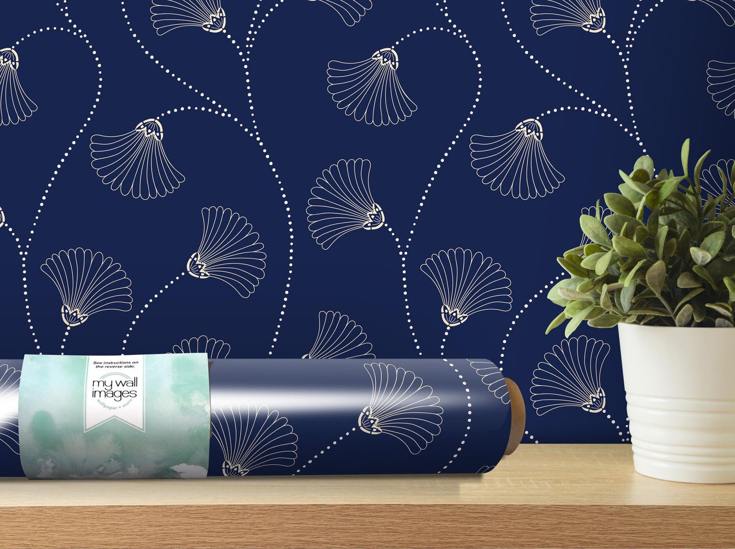 a vase with a plant on a table next to a blue wallpaper