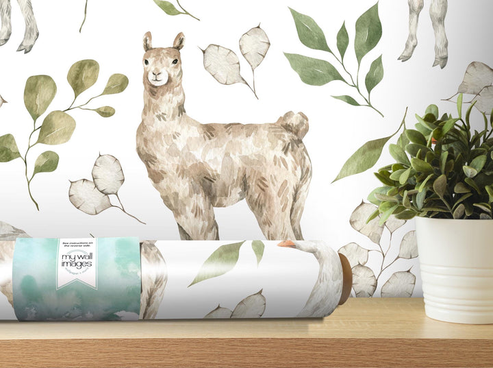 a llama is standing on a table next to a plant