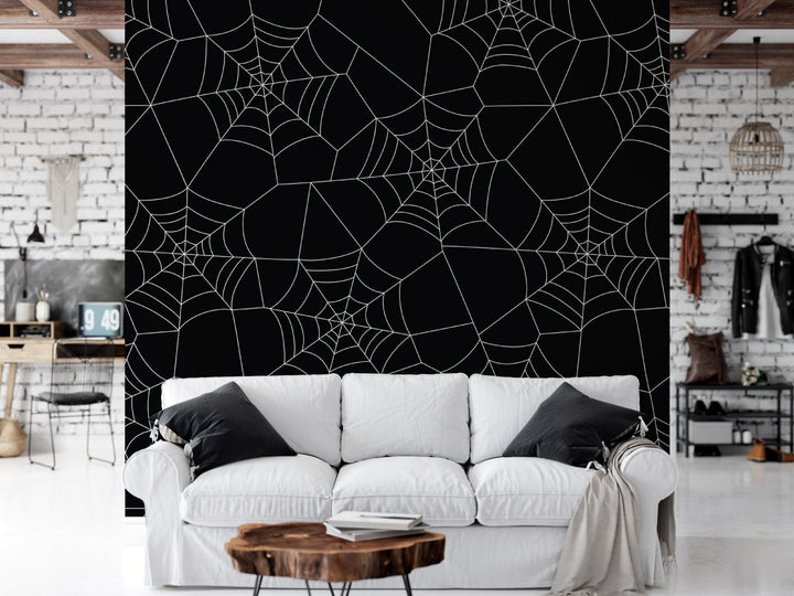a white couch sitting in a living room next to a black wall