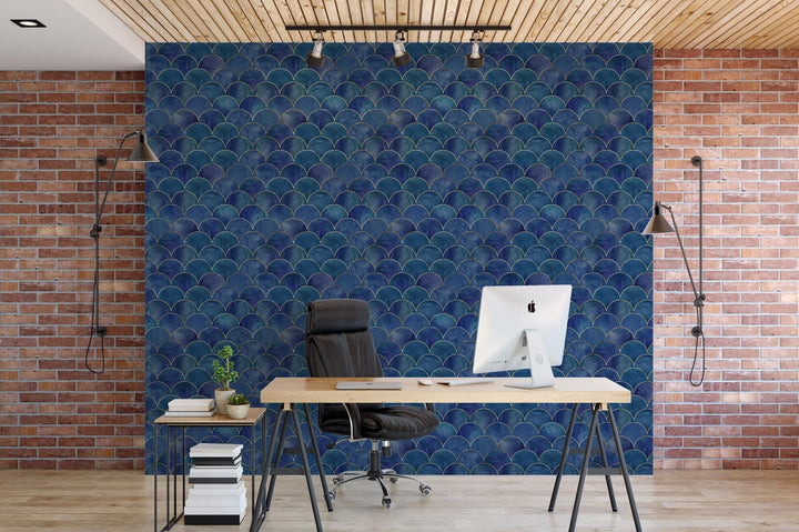 a desk with a computer on it in front of a brick wall