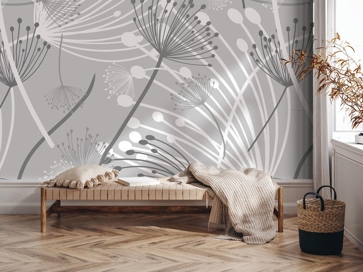 a modern and minimalist interior design with a gray and white floral pattern on the wall behind a wooden bench. The bench is adorned with a throw blanket and a woven basket, adding a touch of coziness to the space. The arrangement of the bench, blanket, and basket creates a visually appealing and inviting atmosphere.
