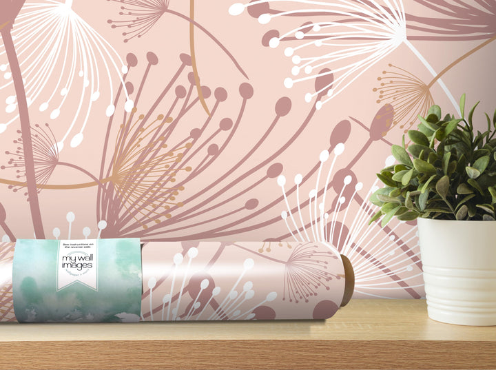 a wallpapered wall with a floral pattern, a potted plant, and a roll of wallpaper on a shelf.