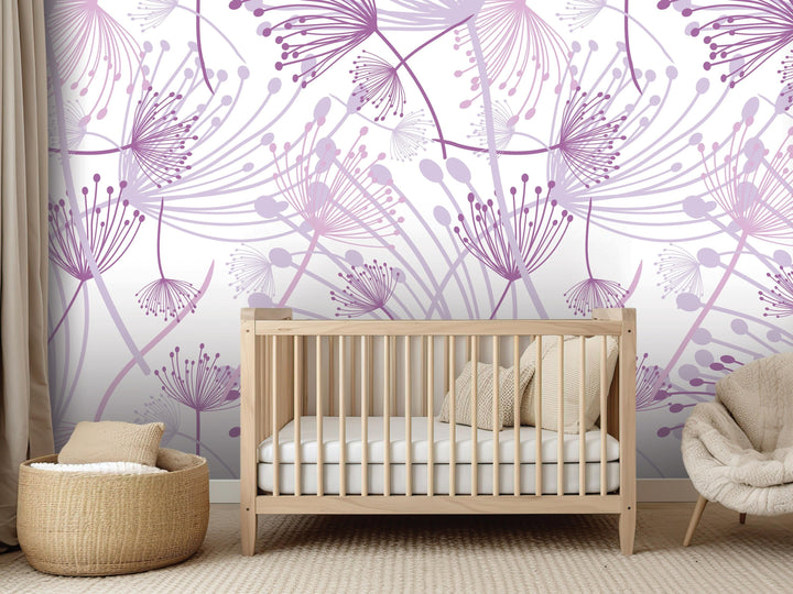 a nursery room with a wooden crib, a beige chair, and a woven basket. The walls are decorated with a purple floral pattern, creating a soothing and calming atmosphere.