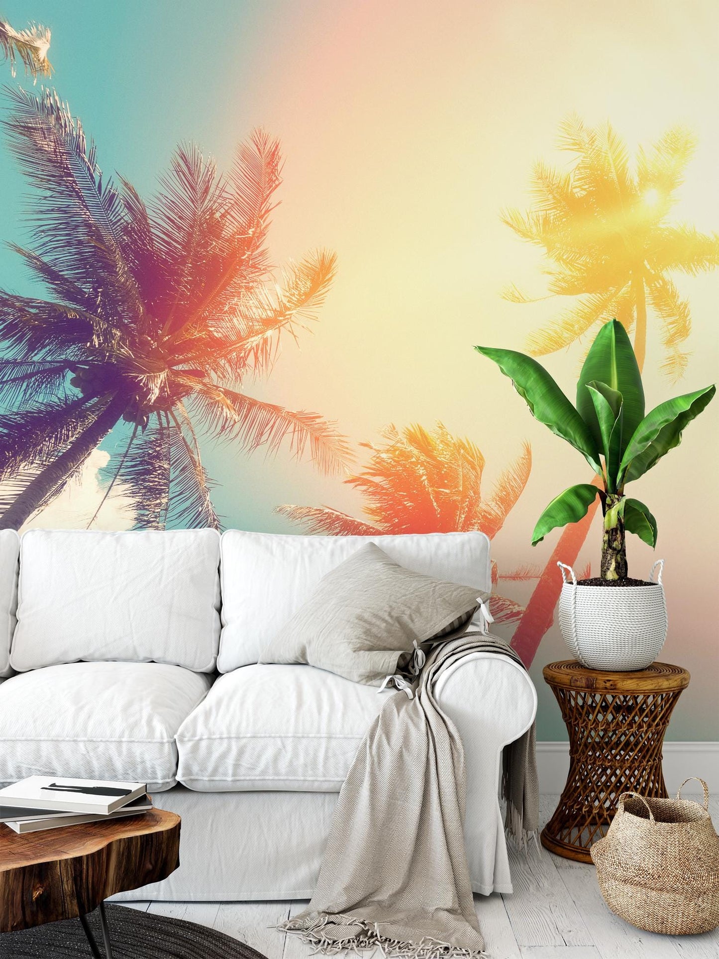 a living room with a white sofa, a wooden side table, and a potted plant. The wall behind the sofa has a vibrant mural depicting palm trees in various shades of green and yellow.