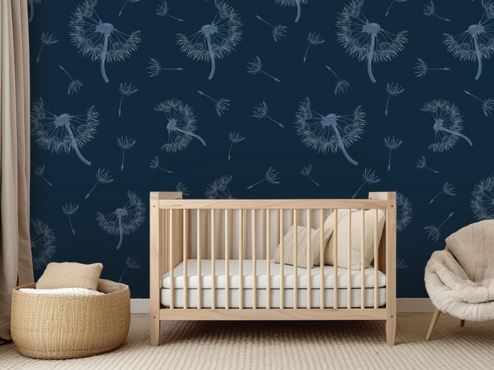 a nursery room with a wooden crib, a beige chair, and a woven basket. The walls are decorated with a blue and white pattern of dandelions, creating a serene and calming atmosphere.