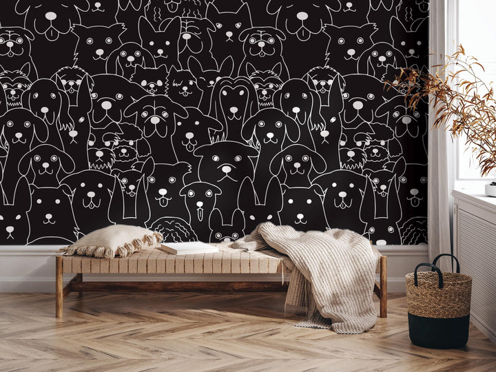 a black and white wall mural depicting a large group of stylized dogs. In the foreground, there is a wooden bench with a blanket draped over it, and a woven basket is placed next to it.