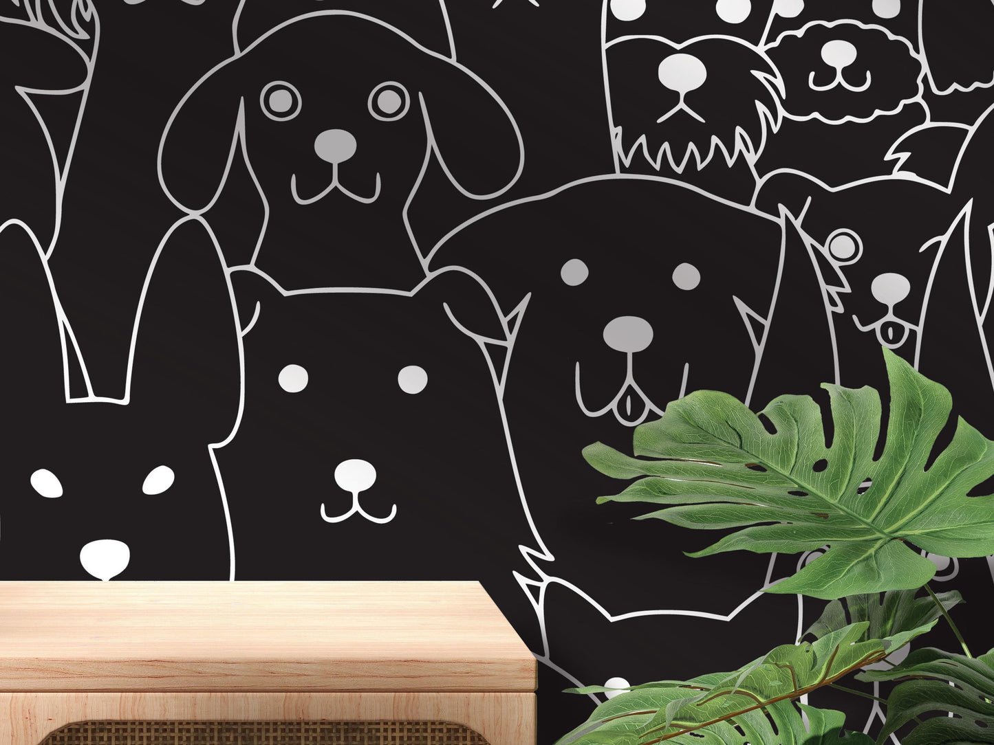 a black and white wall with a variety of stylized dog faces and paw prints, creating a playful and whimsical atmosphere.