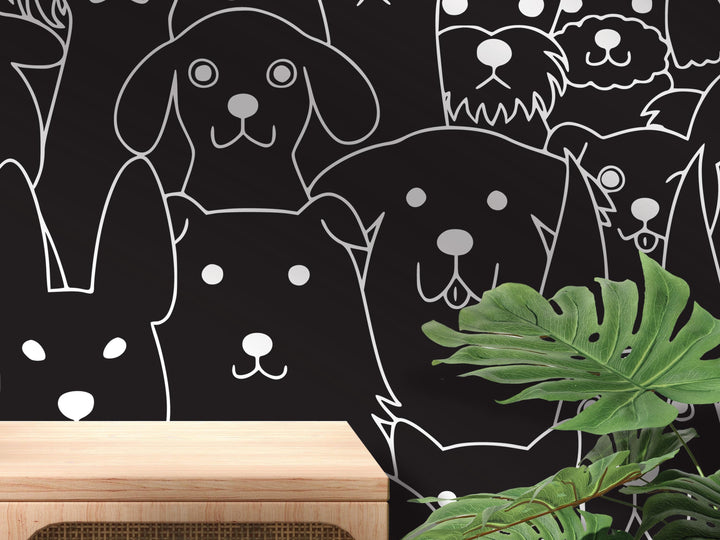 a black and white wall with a variety of stylized dog faces and paw prints, creating a playful and whimsical atmosphere.