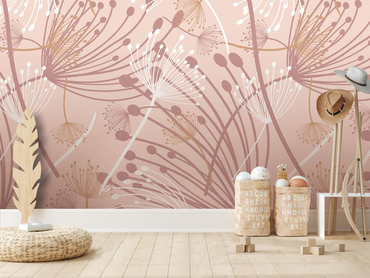 a room with a pink and white floral wallpaper, a wooden floor, and a wicker basket with wooden blocks. There is also a hat and a feather on the floor.