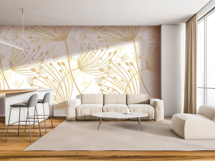 a modern living room with a large wall mural featuring a floral pattern in gold and white colors. The room is furnished with a white sofa, a round coffee table, and a barstool. The overall design and color scheme create a bright and airy atmosphere.