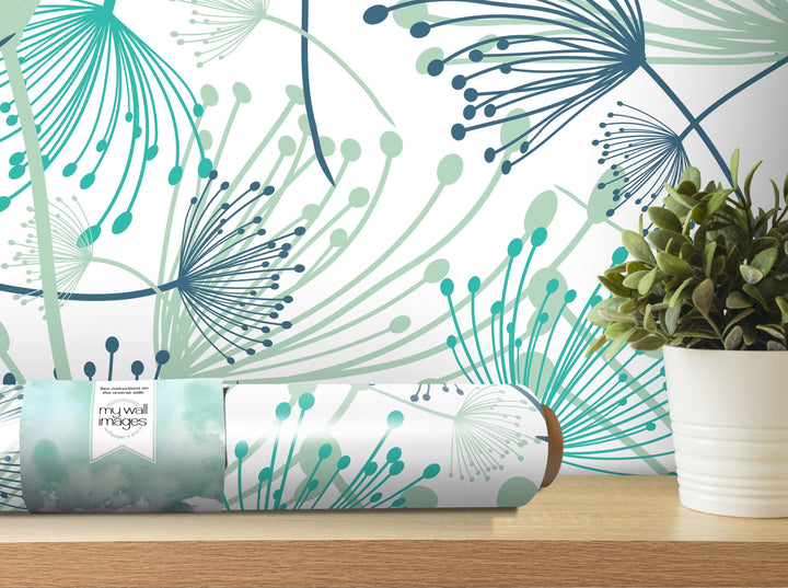 a wallpapered wall with a floral pattern, a potted plant, and a roll of wallpaper on a shelf.