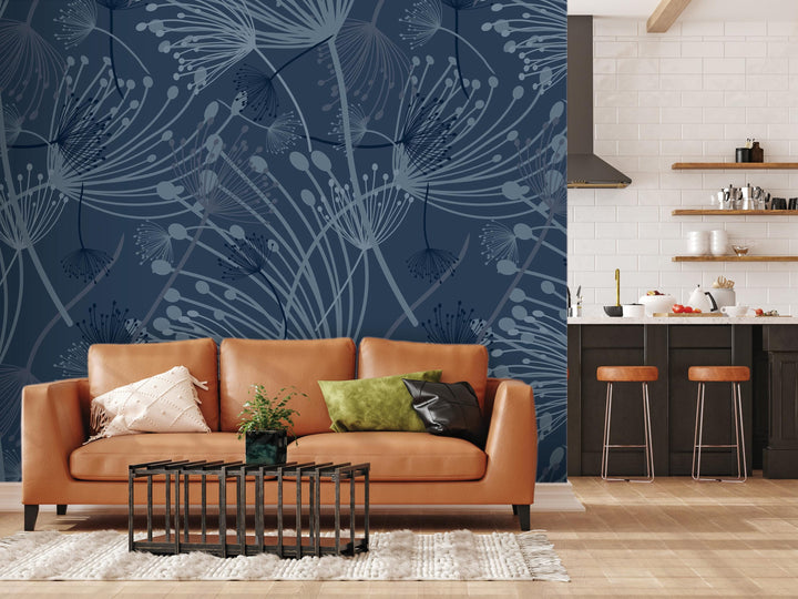 a modern living room with a large wall mural depicting a blue floral pattern. The room is furnished with a brown leather sofa, a black coffee table, and a kitchen counter with stools. The overall design has a contemporary and stylish aesthetic.