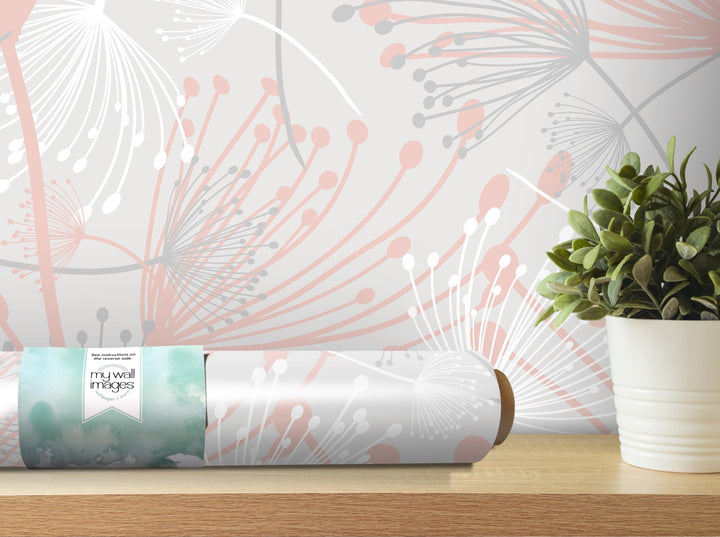 a wallpapered wall with a decorative pattern, a potted plant, and a roll of wallpaper on a shelf.