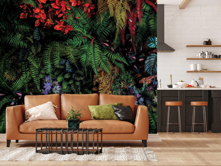 a living room with a large wall mural depicting a lush, tropical jungle scene. The room is furnished with a brown leather sofa, a coffee table, and a kitchen area with a counter and stools.