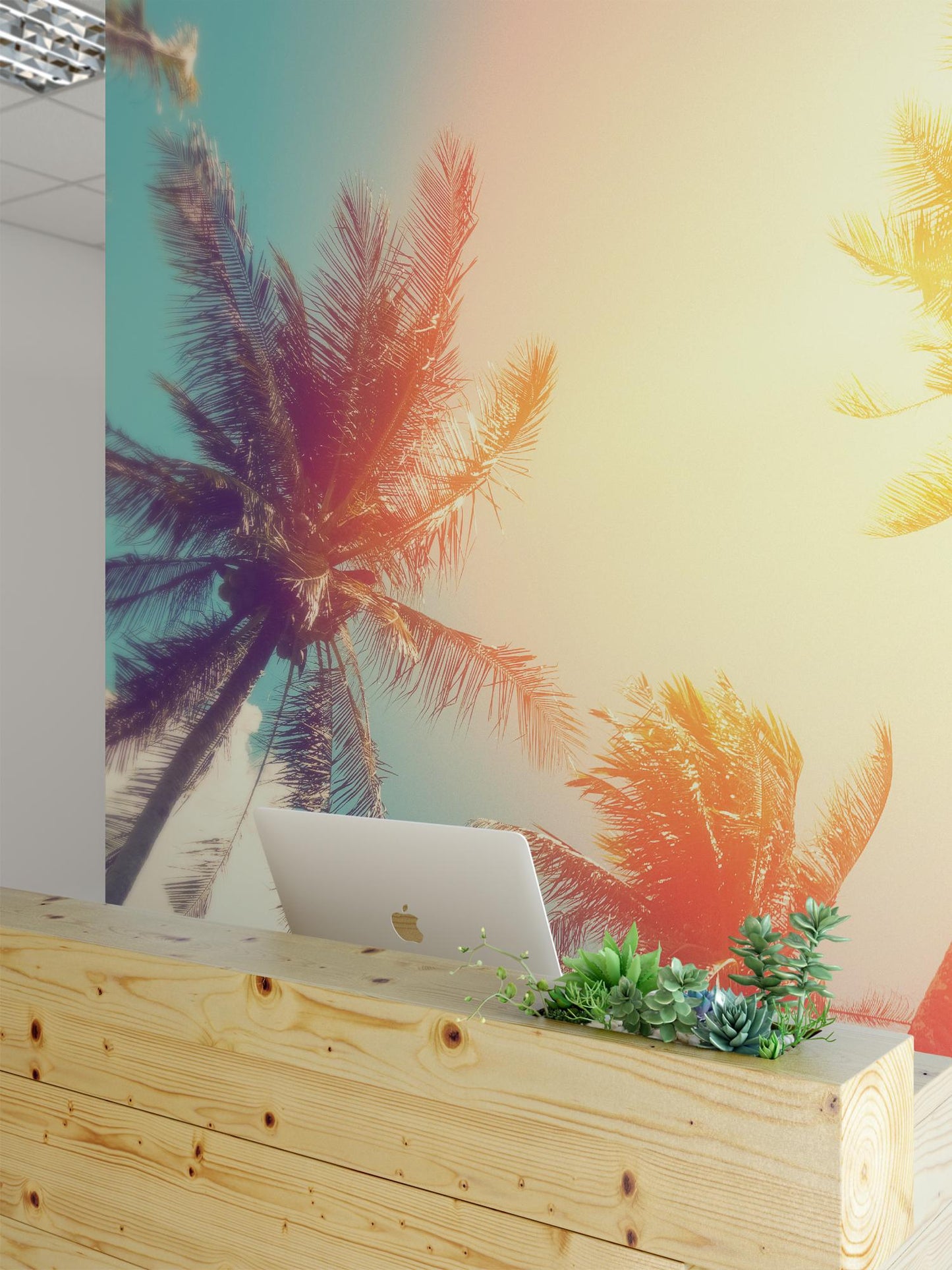 a wooden desk with a laptop on it, set against a vibrant mural of palm trees with a warm, tropical color palette.