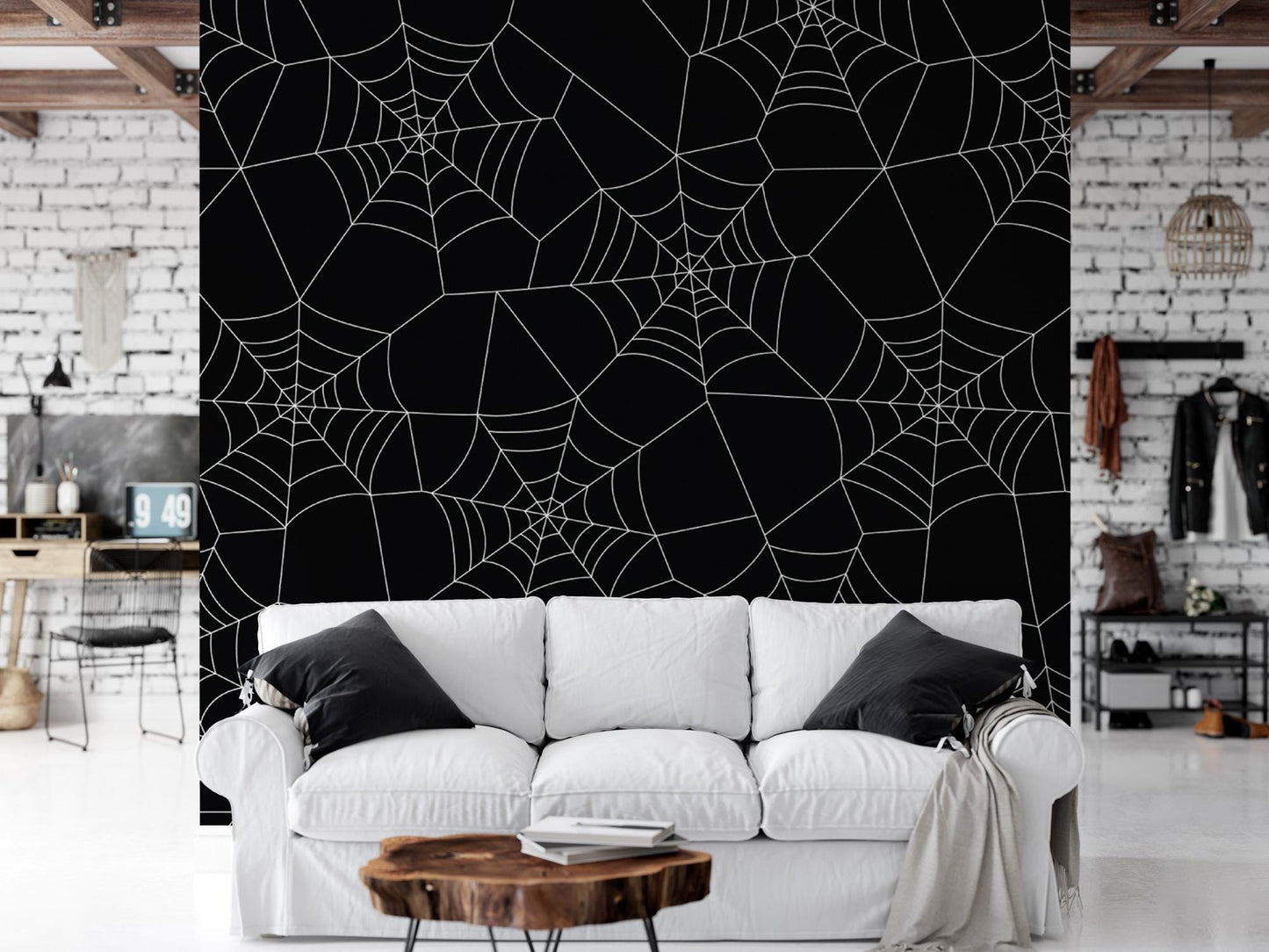 a white couch sitting in a living room next to a black wall
