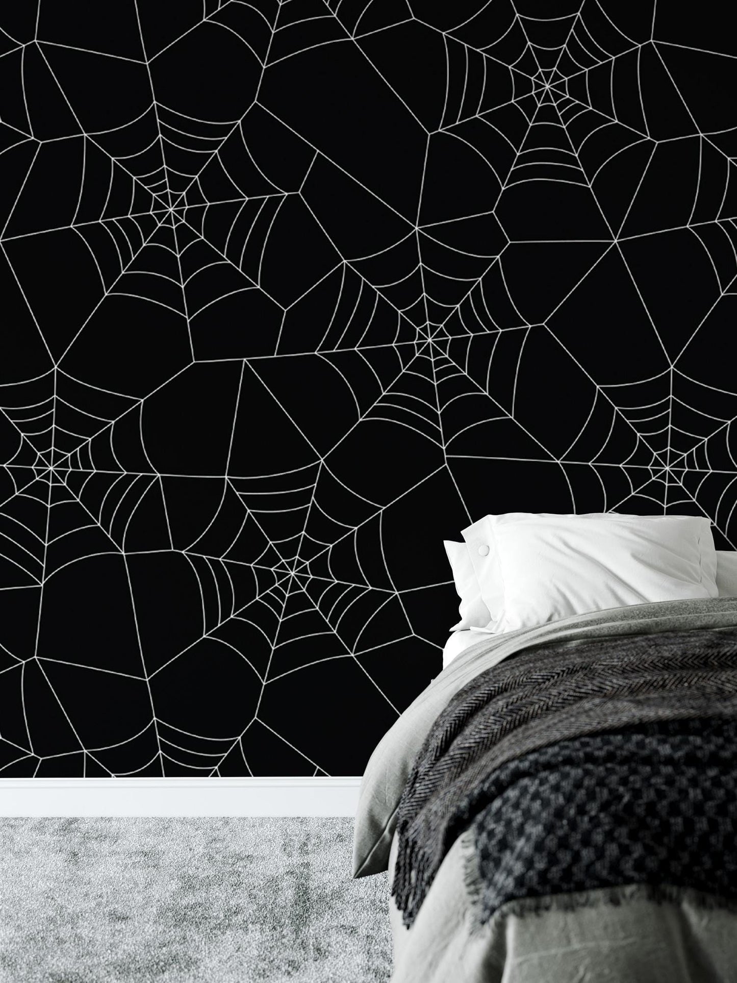 a bedroom with a spider web wallpaper and a bed