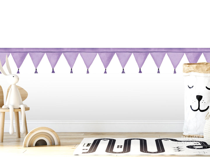 a child&#39;s room with a white wall, a purple border, and a wooden chair. There is a stuffed rabbit and a stuffed bear in the room, along with a toy car and a toy train.