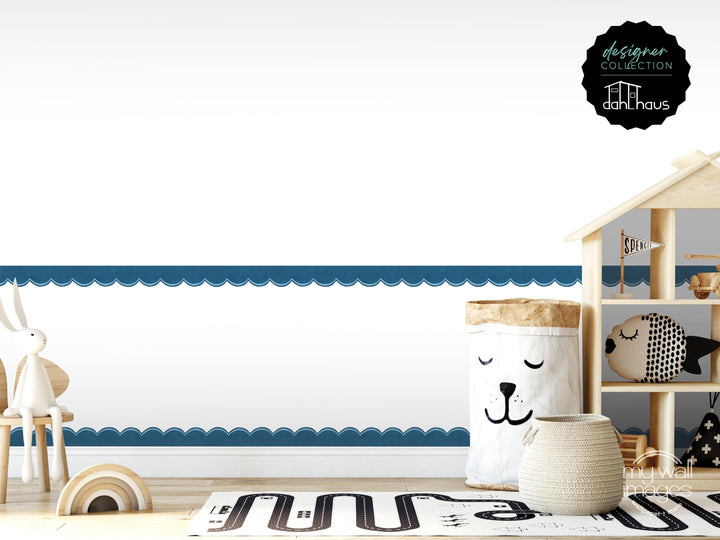 a child&#39;s room with a wooden shelf displaying various toys, a white basket with a face, and a small wooden house. The room has a blue and white color scheme, and the overall layout and arrangement of the objects create a cozy and playful atmosphere.