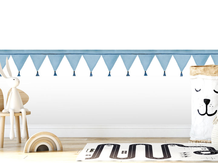 A white rabbit sits on a wooden chair in a room with a white wall, a blue banner, and a toy car on the floor.